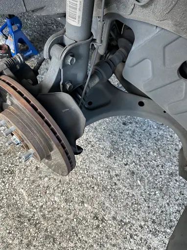 Front brake rotor and strut with the wheel removed for service