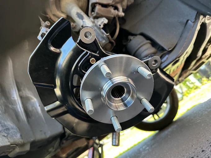 New wheel hub and bearing assembly on a steering knuckle, installed on a car in Jacksonville FL